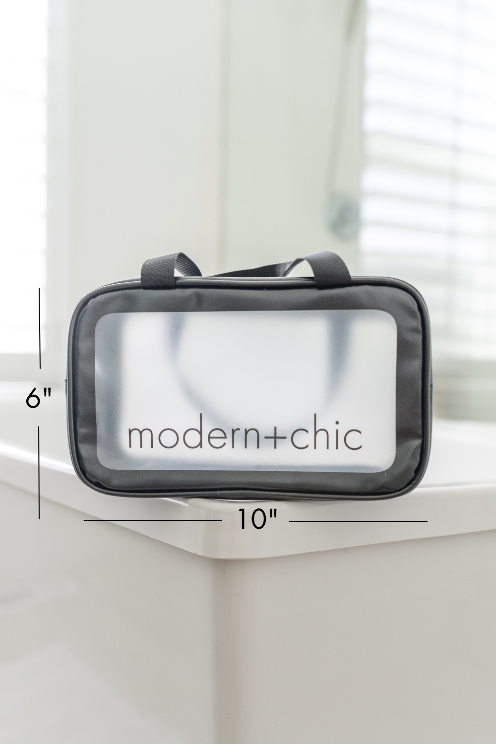 A rectangular clear cosmetic bag with handles.