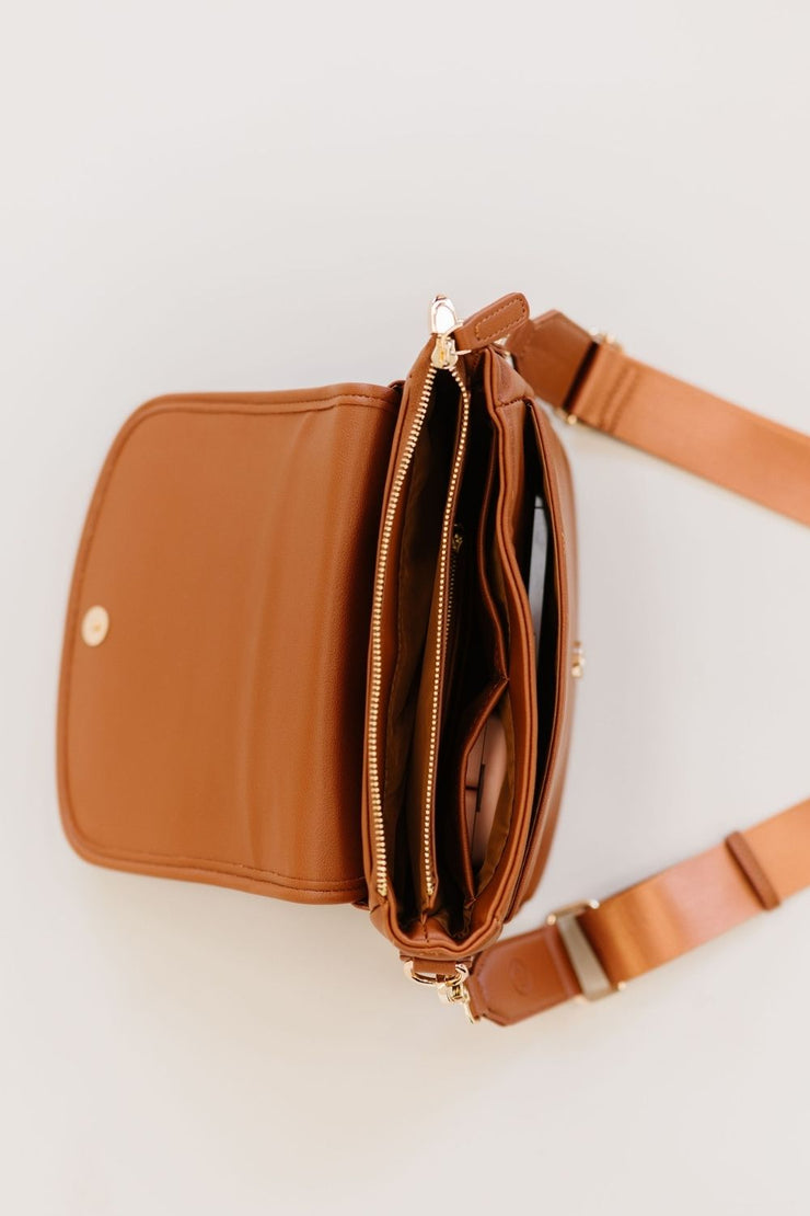 The interior of this crossbody features three compartments—two open and one zippered.