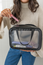A large clear cosmetic bag with handles.
