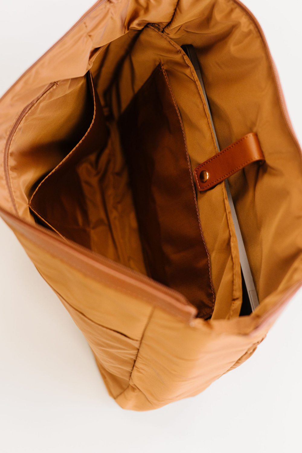 The interior of the matching insert with a laptop sleeve and multiple slot pockets.