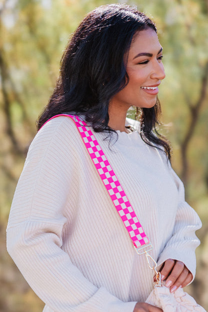Woman wearing a hot pink and white Modern+Chic Lizzie Adjustable purse strap for crossbody bags over her shoulder. 