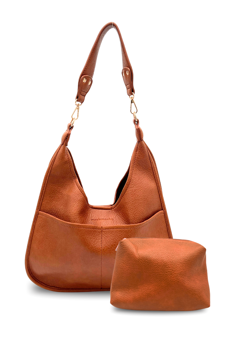 A camel Modern + Chic Clara Vegan Leather Slouchy Tote Bag for Women with coordinating removable zipper pouch on a white background. 
