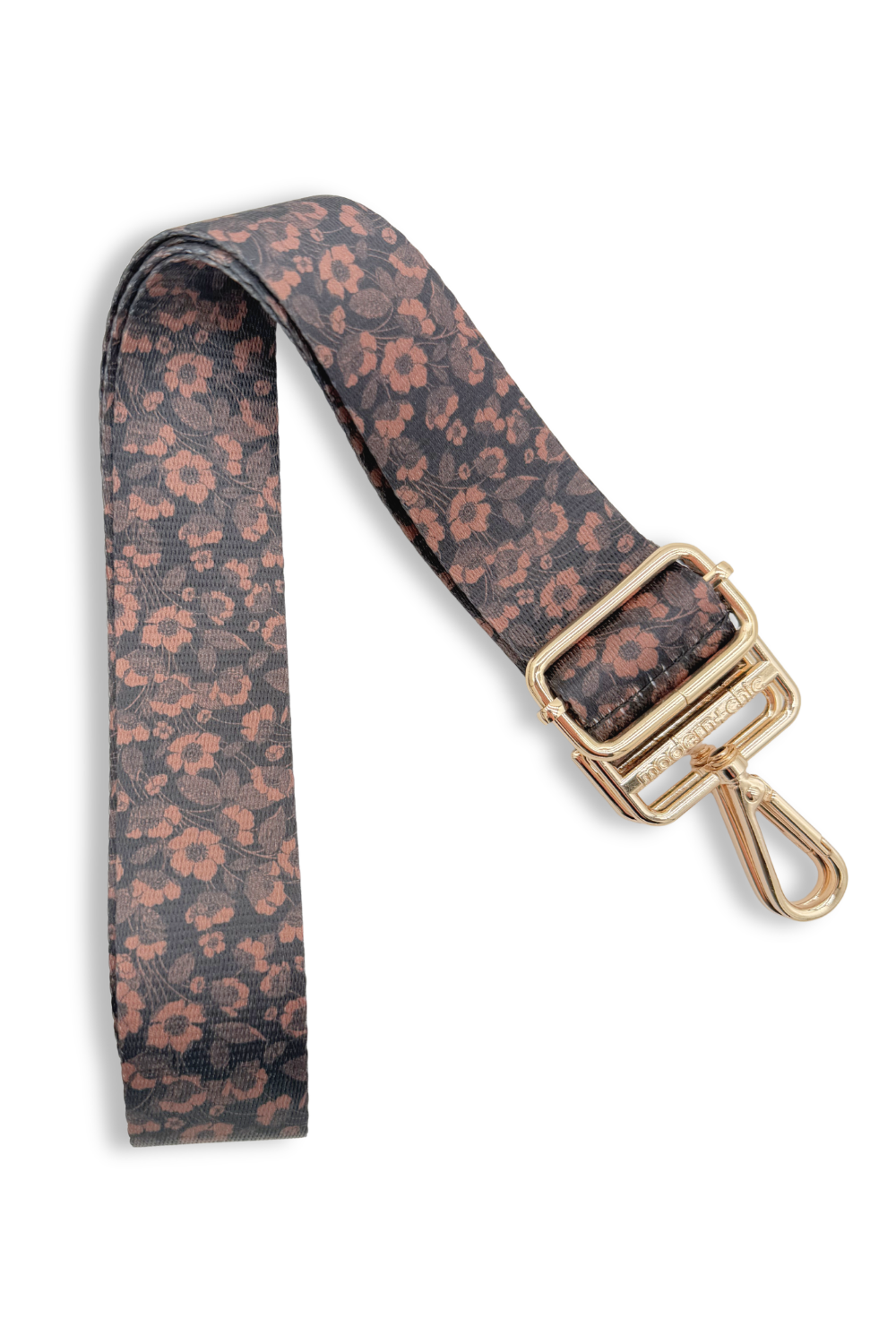 Floral patterned strap with a gold clasp on a white background