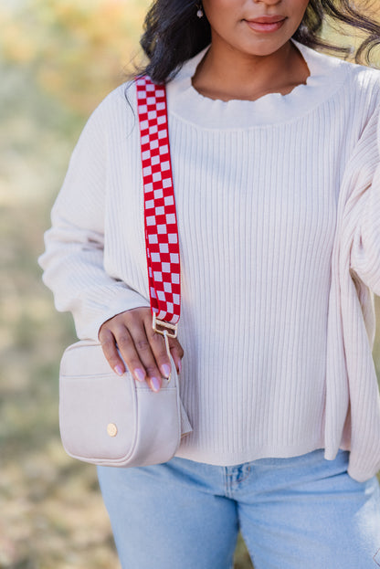 woman wearing a pale pink top and a Modern+Chic pale pink shoulder bag with a coordinating red and pink Modern+Chic Lizzie Checkered adjustable bag strap.