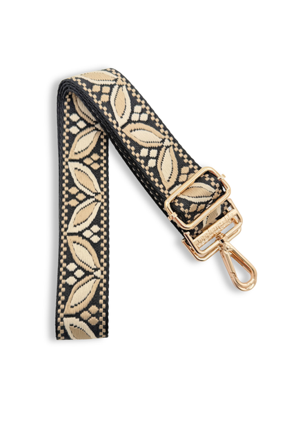 Patterned light taupe colored bag strap with gold clasp on a white background