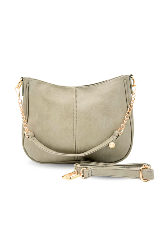 A pebble or pale green Marissa Vegan Leather Saddle Crossbody Bag | Modern + Chic