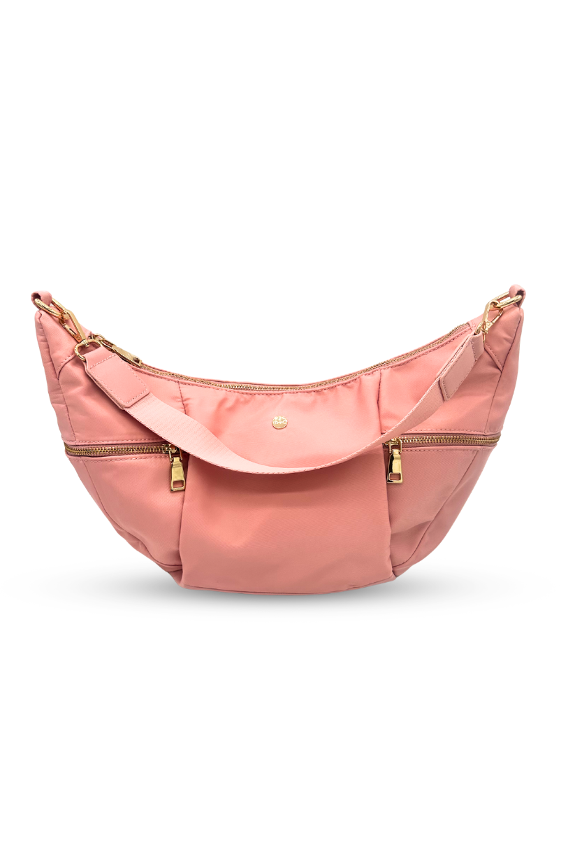Pink Modern + Chic Parker Crescent Crossbody Bag for Women on a white background.