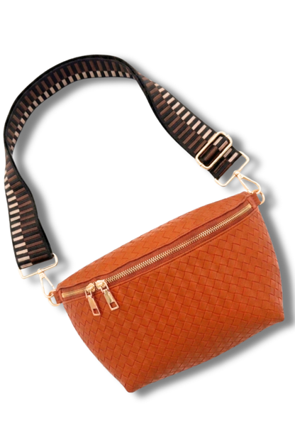 Orange woven belt bag with a brown strap on a white background