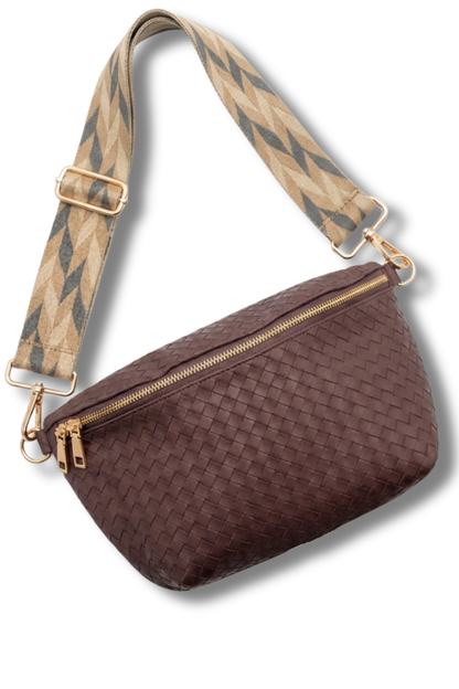 Brown woven handbag with a diamond-patterned strap on a white background